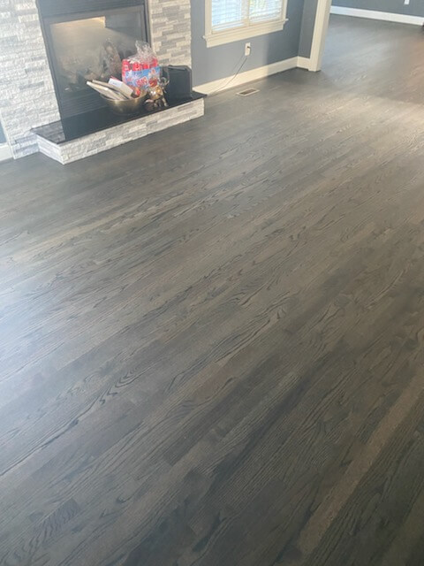 New hardwood floor in front of fireplace